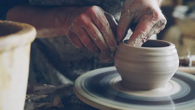 Hands shape a clay pot on a pottery wheel Work in pottery workshop: clay ware on throwing wheel, master ceramist molding clay using professional tools. Creating ceramic utensils an. A beginner tool kit for a home kiln in 2027