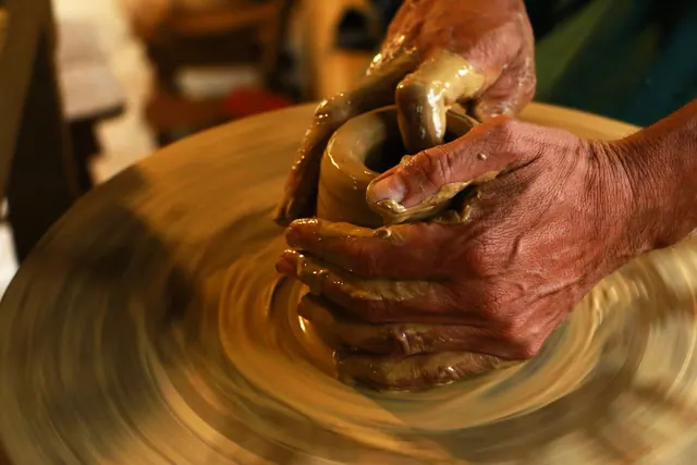 Close-up of hands shaping clay on a pottery wheel, highlighting the art of ceramics. How independent makers avoid the usual studio mistakes