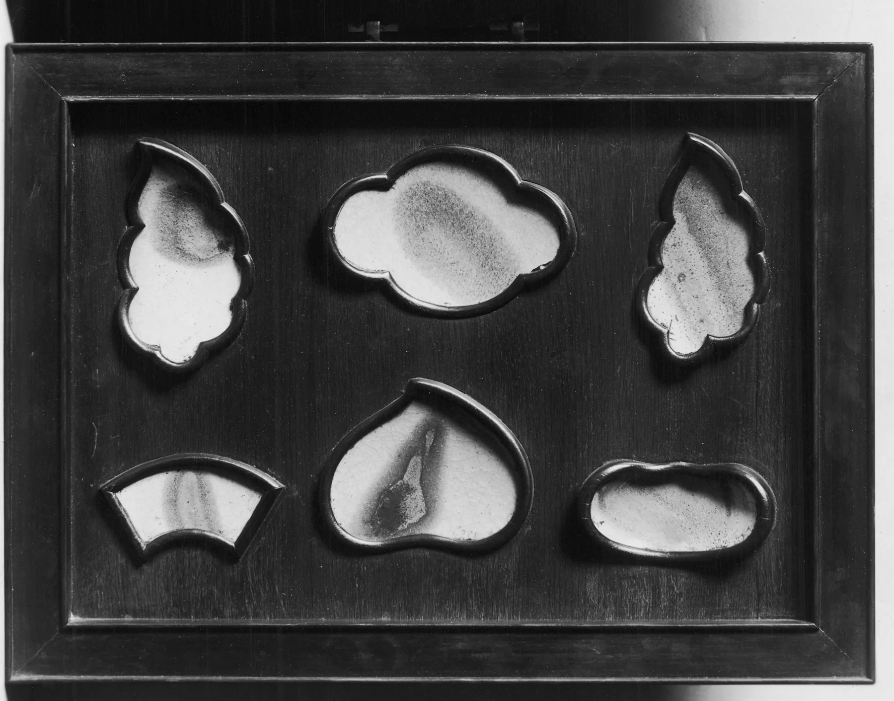 These shards of broken pottery likely date to the Song Dynasty. They were prized for their rich blue and purple colors. The shards were collected and mounted to show off their coloration. This may have taken place at the end fo the 18th century during the Qianlong [Ch'ien-lung] emperor's reign. Why treat pottery losses as a line item in the supply budget?