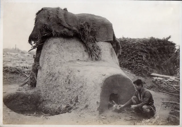 The only thing this structure could possibly be is a kiln for firing pottery. I am assuming there is an opening on the back to create a draft. In my minds eye, the ceramics are stacked or shelved where the structure widens and becomes taller, though I suppose they could also be placed in kiln's lowe. Production studies and youth ceramics records agree on one habit: keep notes